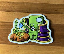 Load image into Gallery viewer, Tiny Dinosaur is about to stab a pumpkin on a wooden surface